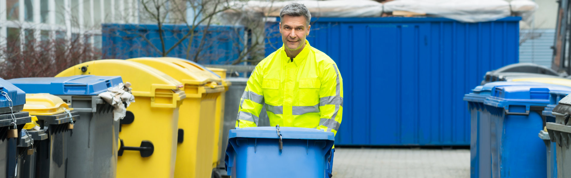 Worker Walking With Dustbin On Street